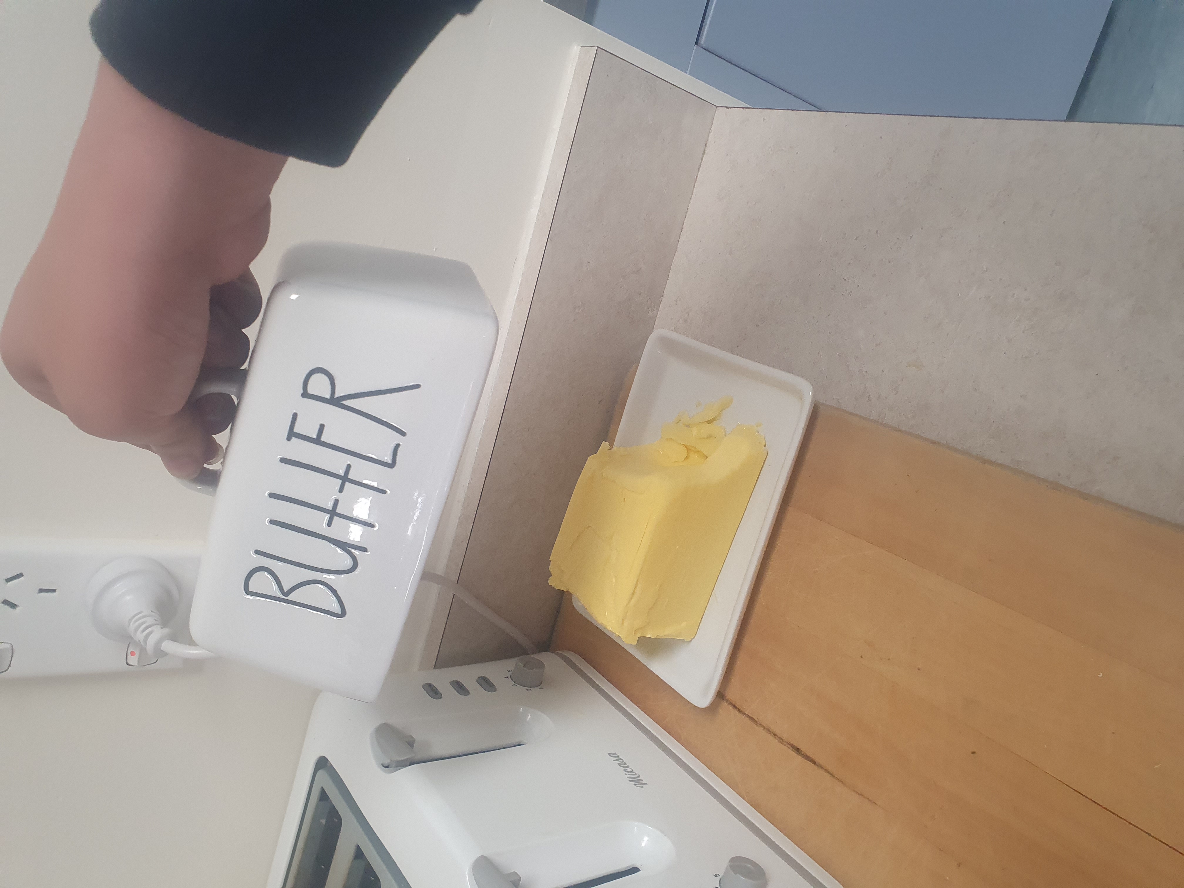 A block of butter in a butter dish