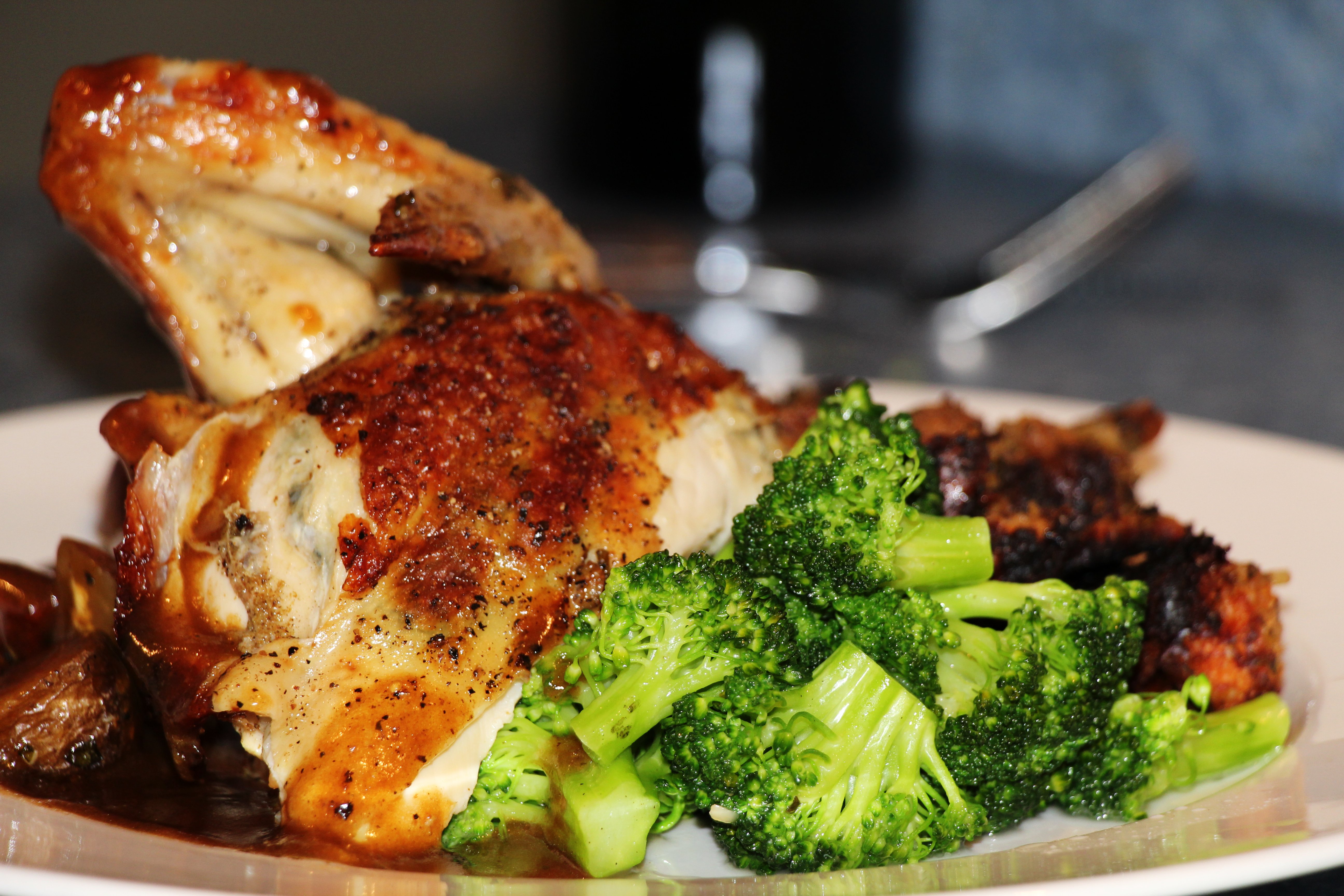 A plate of roast chicken with broccoli