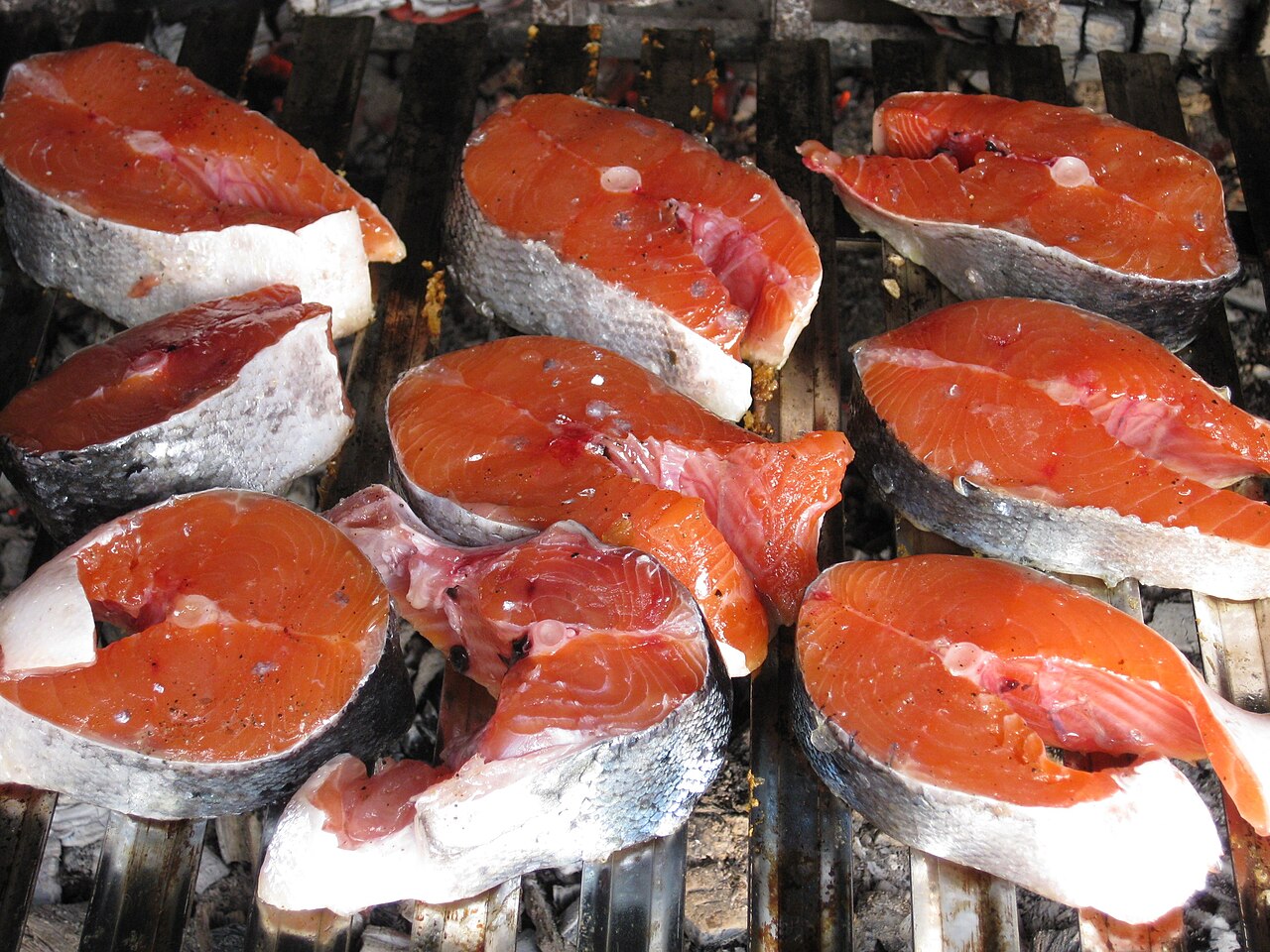 Two raw salmon fillets on a board, ready for wrapping and freezing