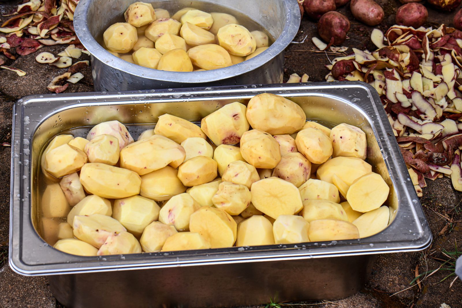 Peeled raw potatoes in water ready for cooking