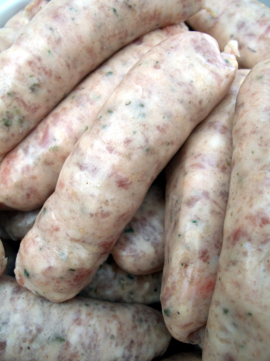 Raw pork sausages on a board