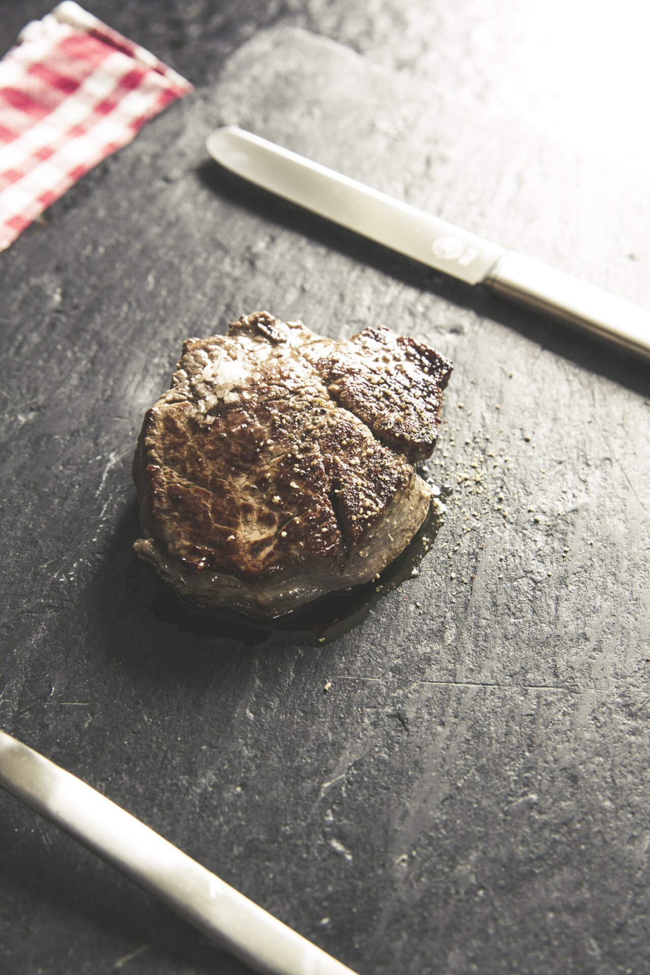 Raw fillet of beef on a wooden board