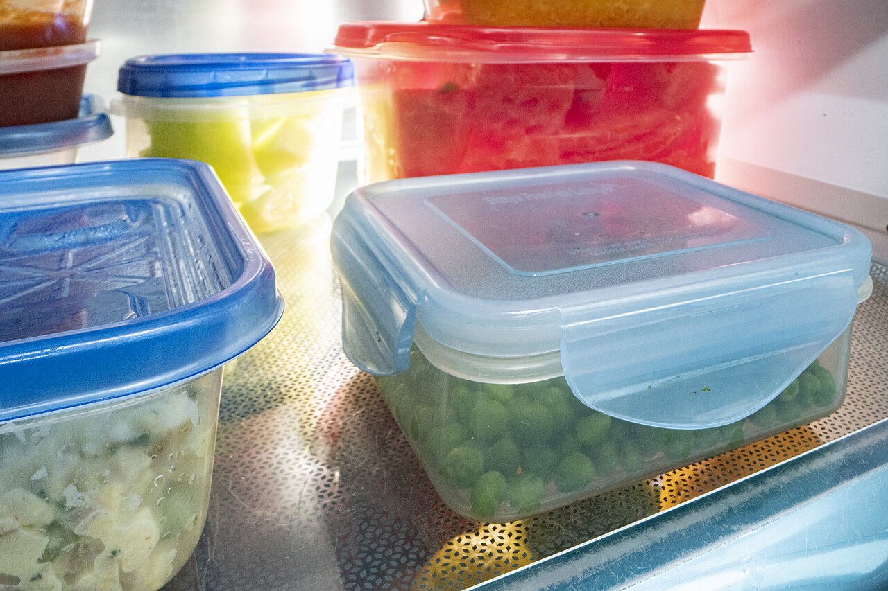 Leftovers stored in clear containers in a fridge