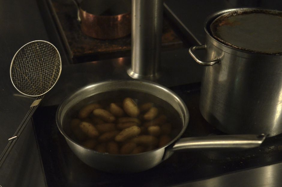 Boiled potatoes simmering in a pan