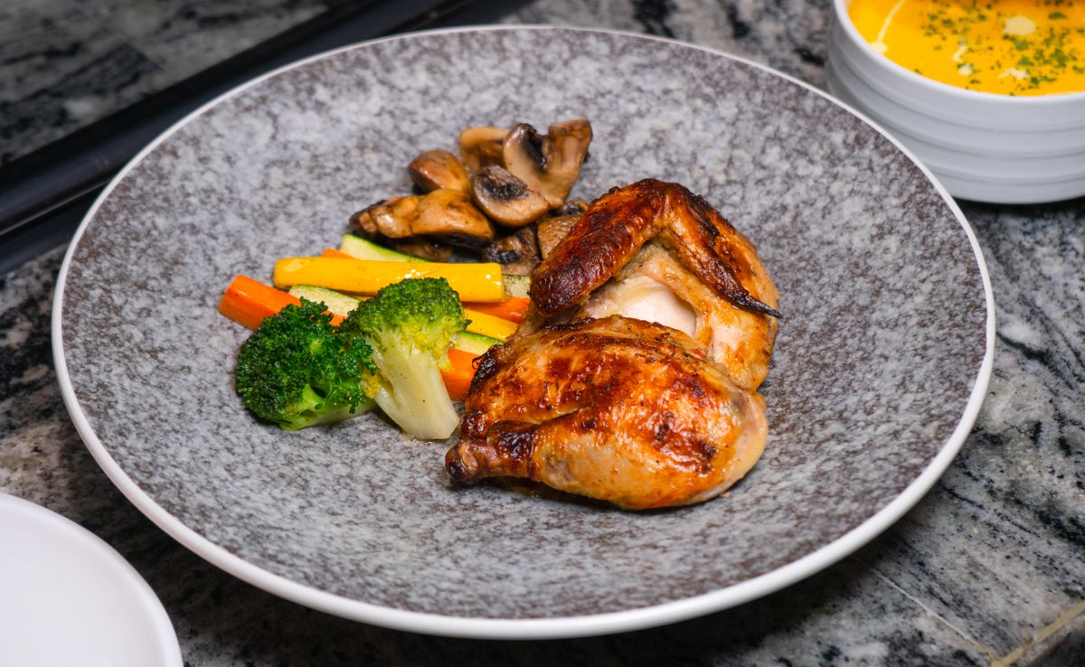 Cooked chicken pieces plated with vegetables