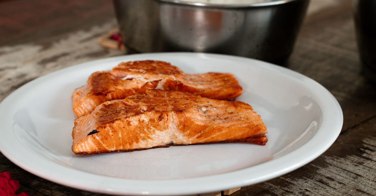 Cooked salmon fillet on a white plate