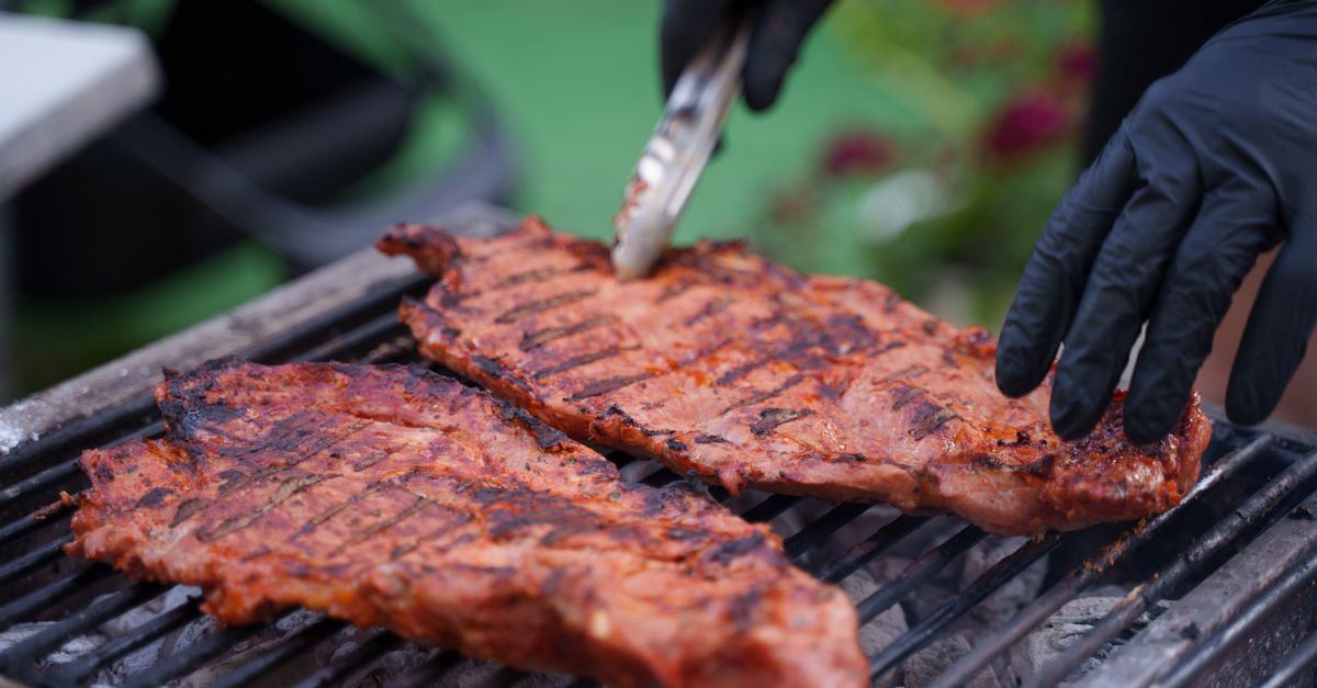 Steaks cooking on a grill